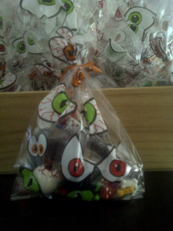 Eyeball party bags with popping candy test tubes, eyeball bouncy balls, skull candy, magnifying glasses and other "mad scientist" goodies