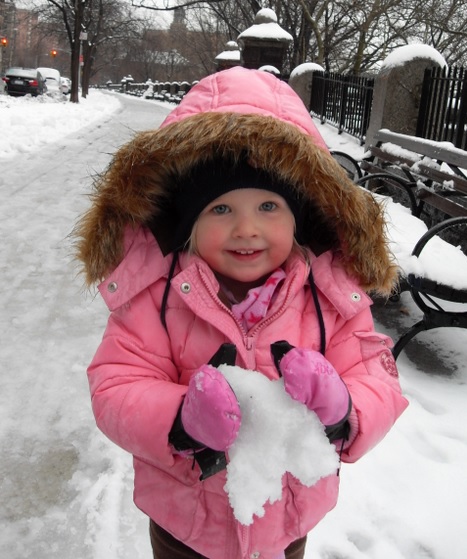 The youngest makes a snowball on Christmas Day.
